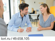 couple is signing a cheque. Стоковое фото, агентство Ingram Publishing / Фотобанк Лори