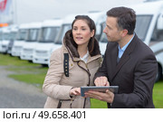 Woman with campervan salesman. Стоковое фото, агентство Ingram Publishing / Фотобанк Лори