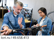 female bicycle part assembler. Стоковое фото, агентство Ingram Publishing / Фотобанк Лори