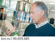 man looking at insoles. Стоковое фото, агентство Ingram Publishing / Фотобанк Лори