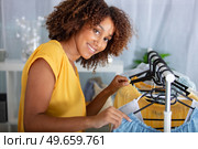 young woman deciding what to put on. Стоковое фото, агентство Ingram Publishing / Фотобанк Лори