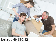 Man shouting at teenager through loudhailer. Стоковое фото, агентство Ingram Publishing / Фотобанк Лори