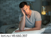 a depressed man in pain on the bed. Стоковое фото, агентство Ingram Publishing / Фотобанк Лори