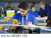 trainee aircraft engineer using a multimeter. Стоковое фото, агентство Ingram Publishing / Фотобанк Лори