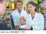 she is writing the dosage instruction. Стоковое фото, агентство Ingram Publishing / Фотобанк Лори