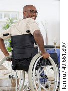 portrait of a disabled man in a wheelchair at home. Стоковое фото, агентство Ingram Publishing / Фотобанк Лори