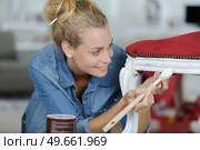 woman painting renewing chair at home. Стоковое фото, агентство Ingram Publishing / Фотобанк Лори