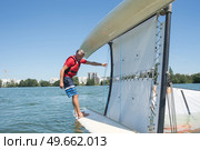 salior trying to right his catamaran after capsize. Стоковое фото, агентство Ingram Publishing / Фотобанк Лори
