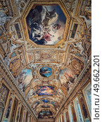 The Galerie d’Apollon a large and iconic room of the Louvre museum. Apollon gallery is a gold decorated hall with zodiac signs ornaments and murals on the walls and ceiling. Architectural masterpiece. Стоковое фото, агентство Ingram Publishing / Фотобанк Лори