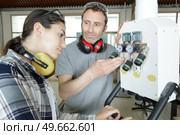 student learns how to repair an industrial power distribution center. Стоковое фото, агентство Ingram Publishing / Фотобанк Лори