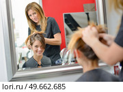 Lady having hair styled in hairdressers. Стоковое фото, агентство Ingram Publishing / Фотобанк Лори