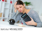 sad woman reading documents at her home. Стоковое фото, агентство Ingram Publishing / Фотобанк Лори