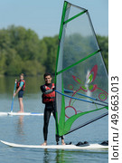 a man is doing windsurf. Стоковое фото, агентство Ingram Publishing / Фотобанк Лори
