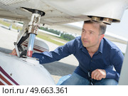 a man checking an aircraft. Стоковое фото, агентство Ingram Publishing / Фотобанк Лори