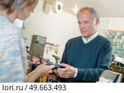 Man having his shoes repaired. Стоковое фото, агентство Ingram Publishing / Фотобанк Лори