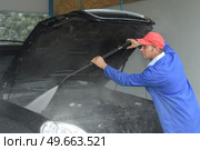image of worker cleaning the cars engine with a karcher. Стоковое фото, агентство Ingram Publishing / Фотобанк Лори