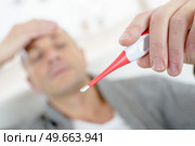 close-up of a sick man holding thermometer. Стоковое фото, агентство Ingram Publishing / Фотобанк Лори