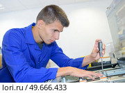 young technician fix office photo copier. Стоковое фото, агентство Ingram Publishing / Фотобанк Лори