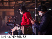 masked cameraman is filming a television show in the studio. TV. Стоковое фото, агентство Ingram Publishing / Фотобанк Лори