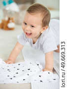 crawling funny baby boy indoors at home. Стоковое фото, агентство Ingram Publishing / Фотобанк Лори