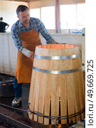 a male cooper making a barrel. Стоковое фото, агентство Ingram Publishing / Фотобанк Лори