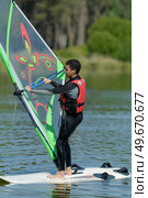 a nice sportman is doing windsurf. Стоковое фото, агентство Ingram Publishing / Фотобанк Лори