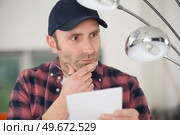 a construction worker checking lights. Стоковое фото, агентство Ingram Publishing / Фотобанк Лори
