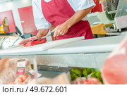 a butcher is working with bio meat. Стоковое фото, агентство Ingram Publishing / Фотобанк Лори