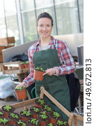 inspired smiling woman worker in greenhouse. Стоковое фото, агентство Ingram Publishing / Фотобанк Лори