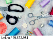 Set sewing kit, scissors, threads, needles and colorful thread. Needlework concept. Top view, flat lay. Various sewing tools. Стоковое фото, агентство Ingram Publishing / Фотобанк Лори