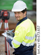 land surveyor at work on a construction site. Стоковое фото, агентство Ingram Publishing / Фотобанк Лори