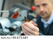 handyman making door keys copies. Стоковое фото, агентство Ingram Publishing / Фотобанк Лори