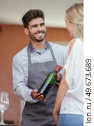wine vendor showing product to client. Стоковое фото, агентство Ingram Publishing / Фотобанк Лори