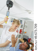 a woman testing smoke detector. Стоковое фото, агентство Ingram Publishing / Фотобанк Лори
