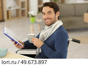 handsome handicapped man in wheelchair having a coffee. Стоковое фото, агентство Ingram Publishing / Фотобанк Лори