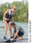 learning to wakeboarding on a lake. Стоковое фото, агентство Ingram Publishing / Фотобанк Лори