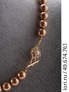 author handmade golden  pearls necklace presented on maneken. fashion and jewelry concept. macro shot. Стоковое фото, агентство Ingram Publishing / Фотобанк Лори