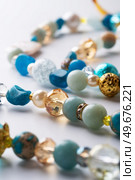 author trend necklace with different  beads  demonstrated  against white background. fashion and jewelry concept. Стоковое фото, агентство Ingram Publishing / Фотобанк Лори