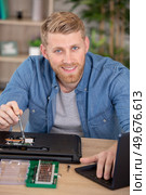 male student during repair of his laptop. Стоковое фото, агентство Ingram Publishing / Фотобанк Лори