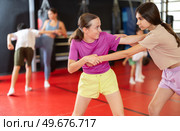 Girls practice self-defense strikes in the gym. Стоковое фото, фотограф Яков Филимонов / Фотобанк Лори