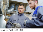 two male engineers with vernier gauge. Стоковое фото, агентство Ingram Publishing / Фотобанк Лори