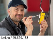 electrician checking wiring on electrical switch. Стоковое фото, агентство Ingram Publishing / Фотобанк Лори
