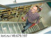 warehouse worker going up the stairs. Стоковое фото, агентство Ingram Publishing / Фотобанк Лори