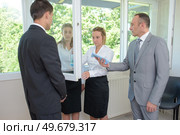 trainee cleaning a mirror under supervision. Стоковое фото, агентство Ingram Publishing / Фотобанк Лори
