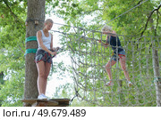 women moving forwards in an adventure park. Стоковое фото, агентство Ingram Publishing / Фотобанк Лори