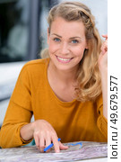 woman sat by campervan route planning on map. Стоковое фото, агентство Ingram Publishing / Фотобанк Лори