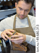 attaching the shoe sole. Стоковое фото, агентство Ingram Publishing / Фотобанк Лори