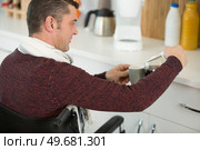 disabled man preparing a coffee in kitchen. Стоковое фото, агентство Ingram Publishing / Фотобанк Лори