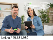 young couple playing with a small quadrocopter drone. Стоковое фото, агентство Ingram Publishing / Фотобанк Лори