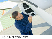 portrait of man mechanic inspecting aircraft. Стоковое фото, агентство Ingram Publishing / Фотобанк Лори